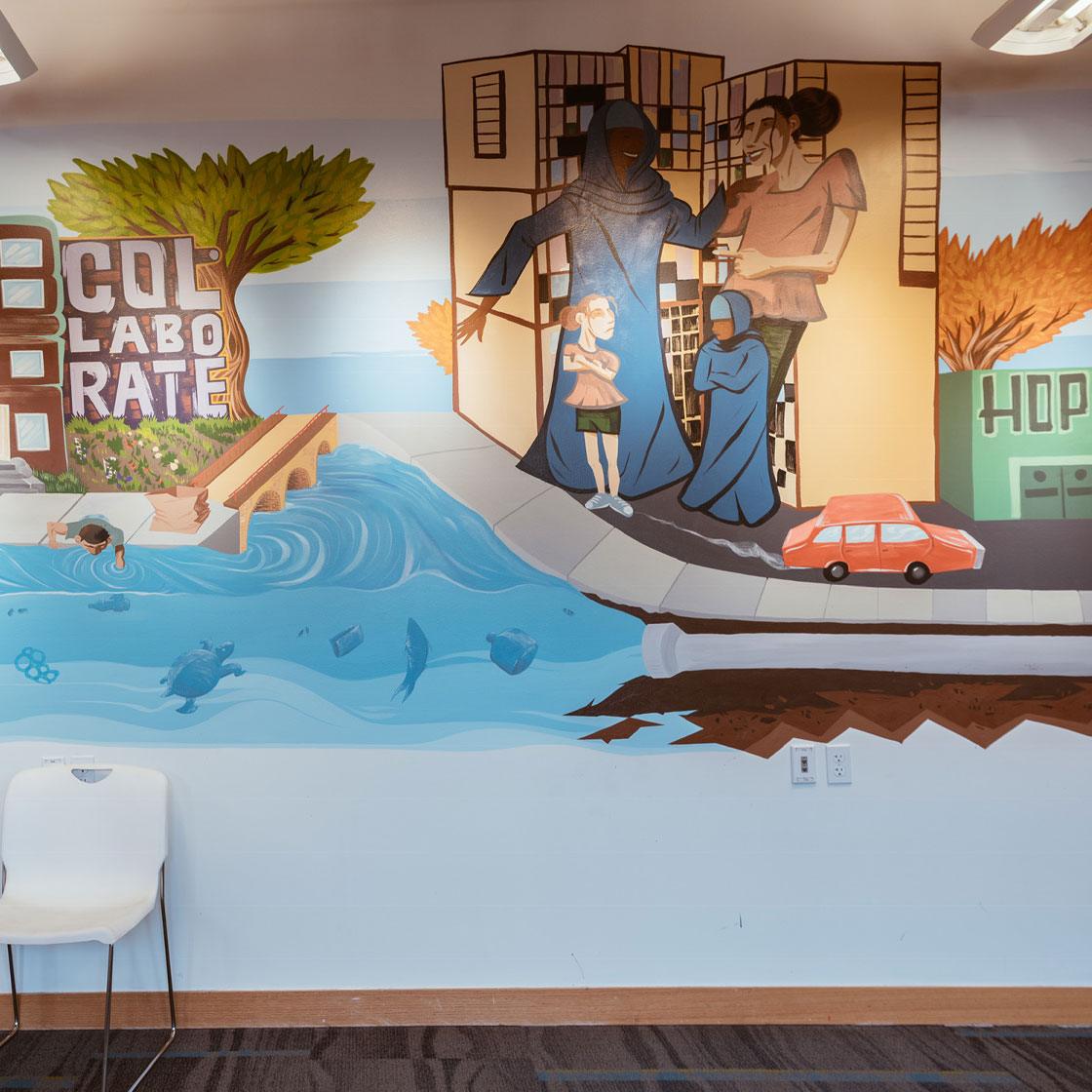An office space decorated with a painted mural of a cityscape