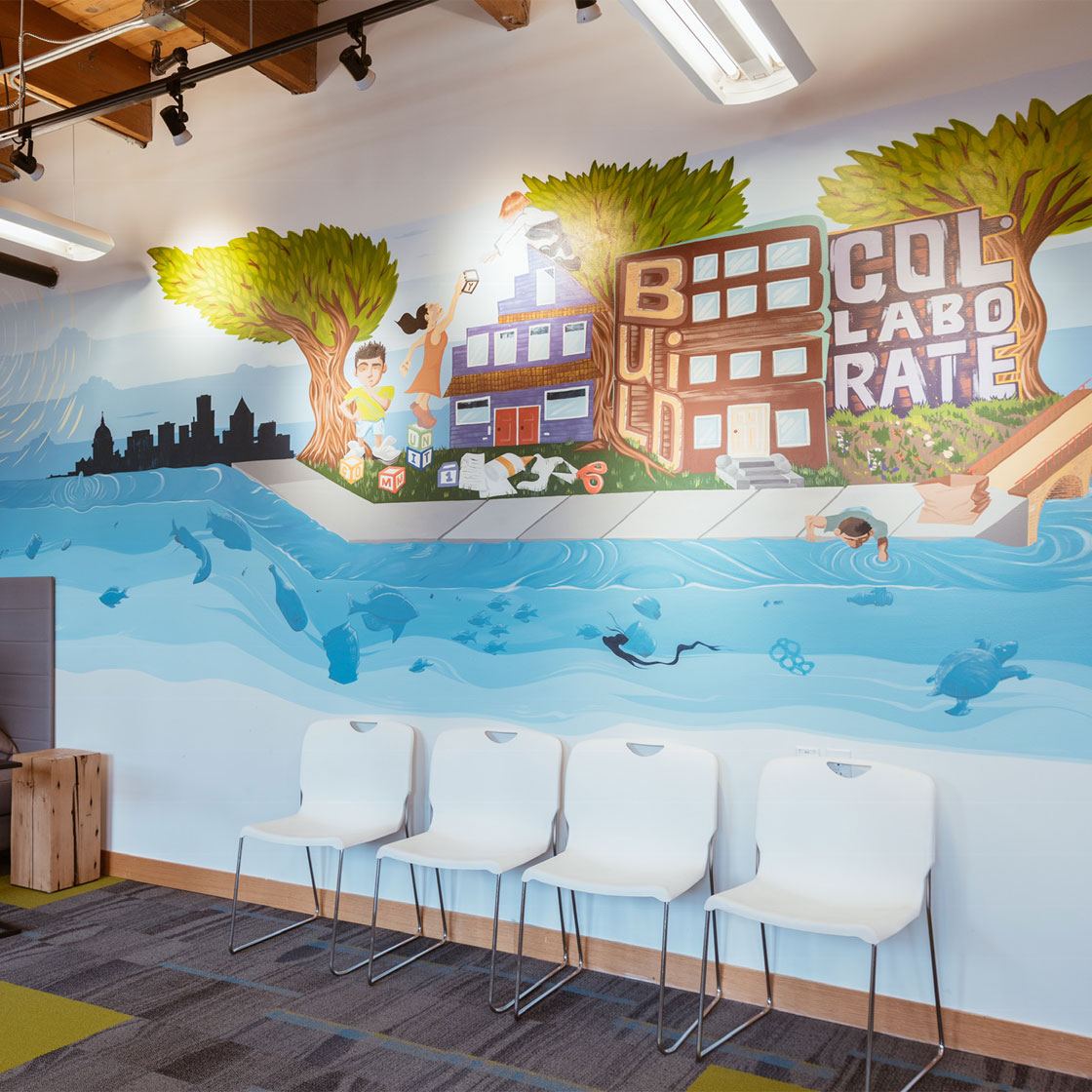 An office space decorated with a painted mural of a cityscape