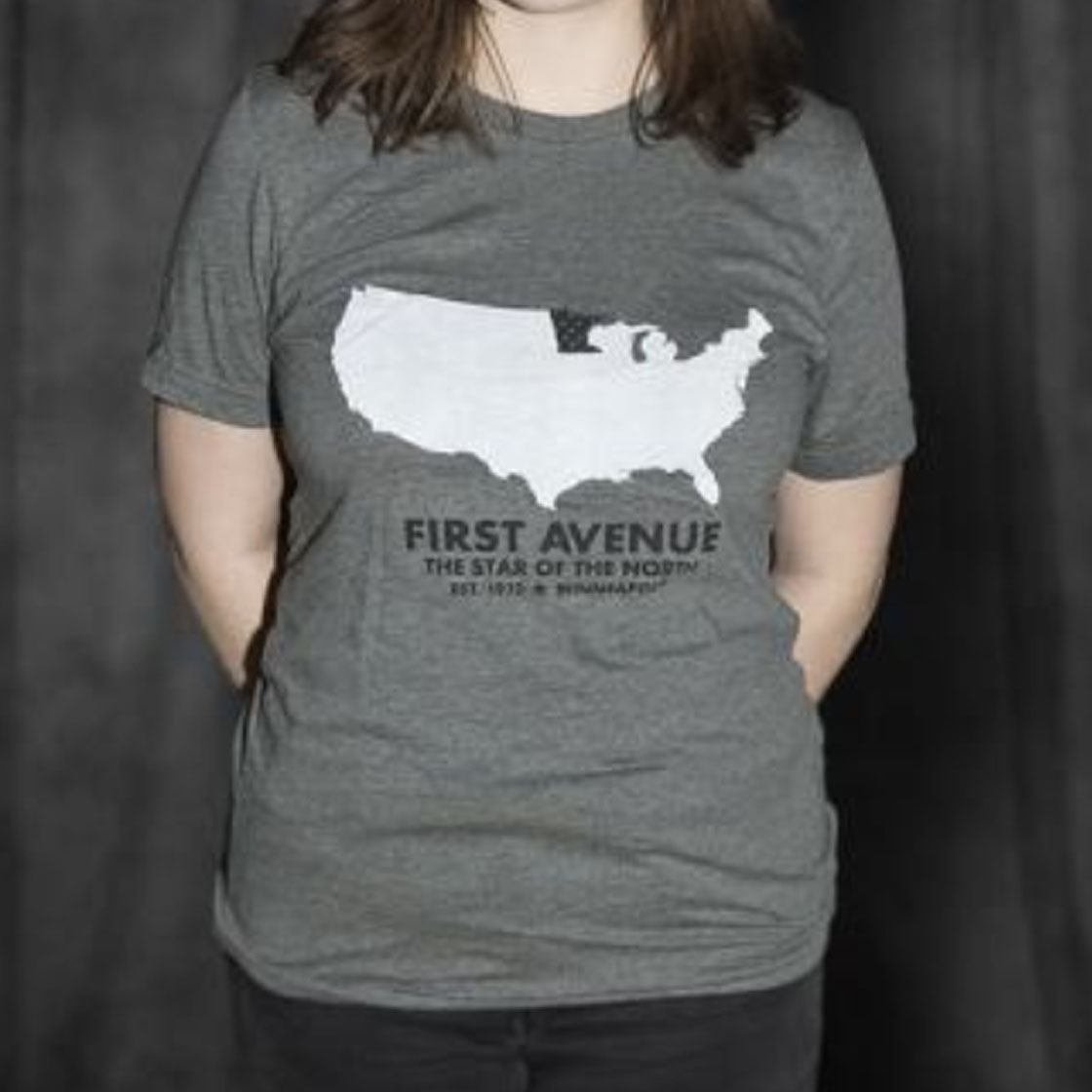 Someone wearing a t shirt with an image of the United States and the words First Avenue