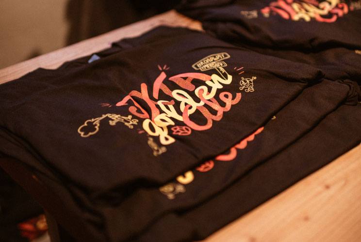 Decorative screen printed shirts with a decorative design with the words JXTA golden ale
