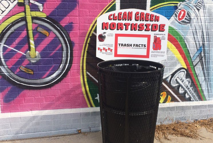 A trash can labeled with a sign reading clean green northside