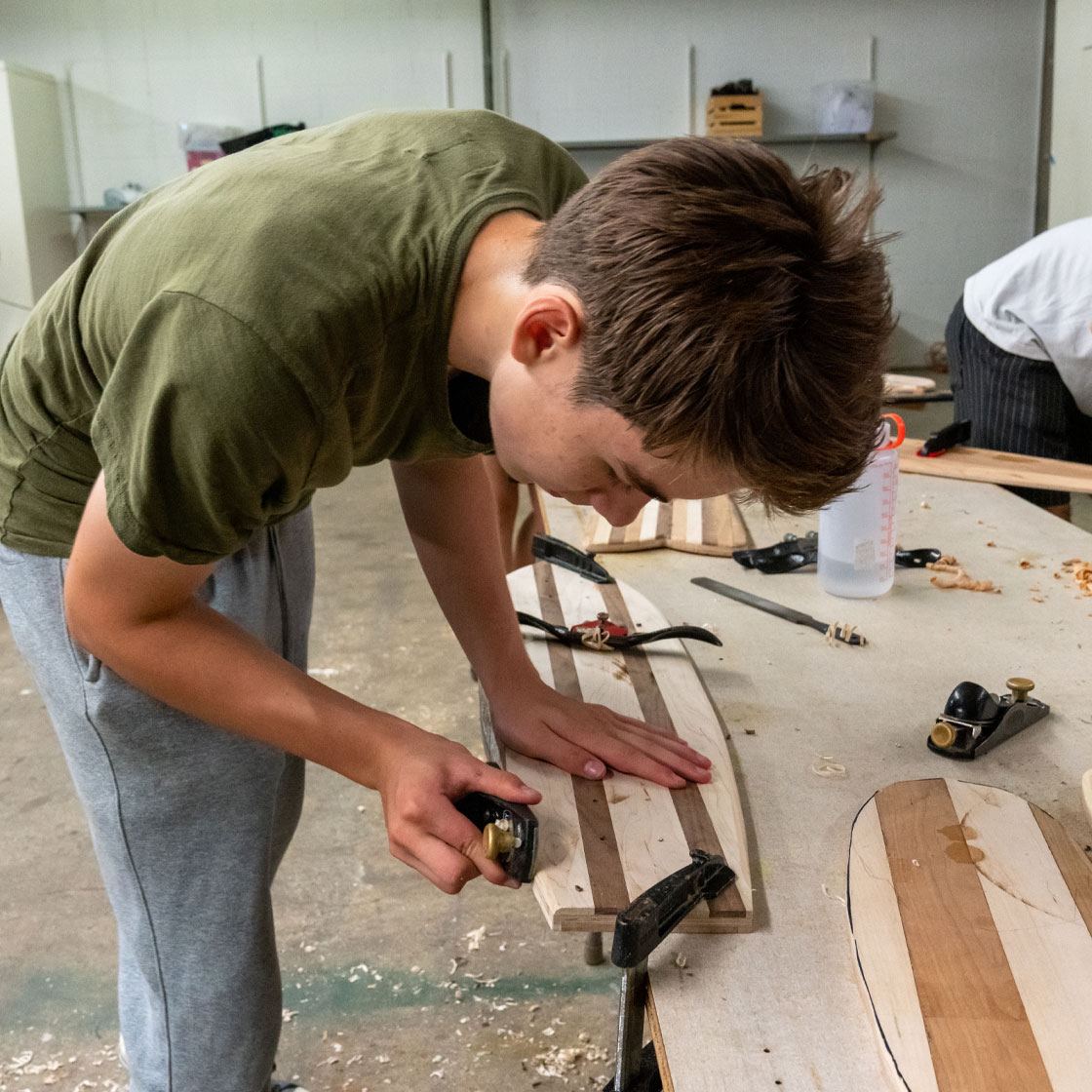 A young person working on a woodworking project