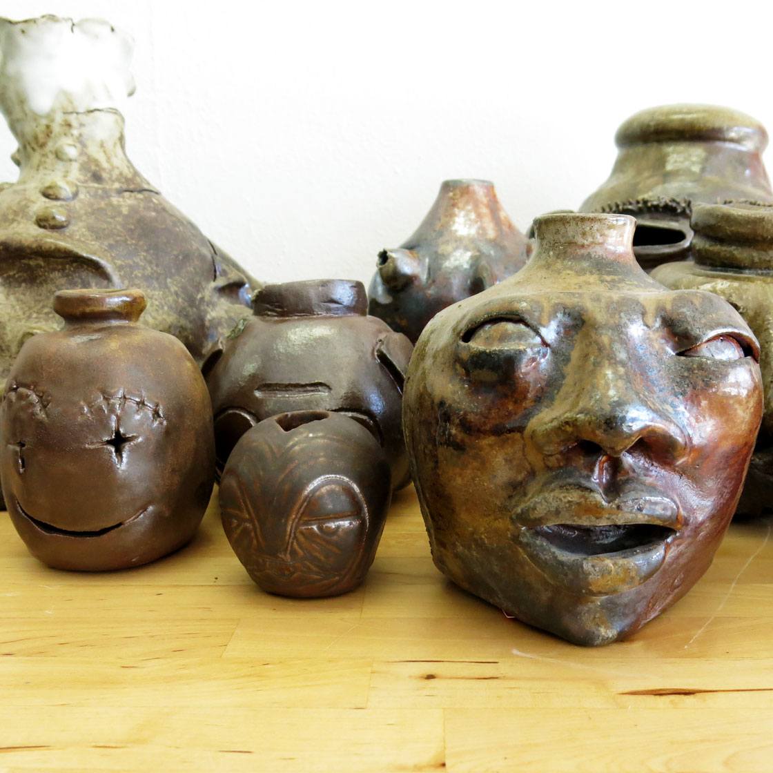 Handcrafted ceramic works in various abstract face shapes