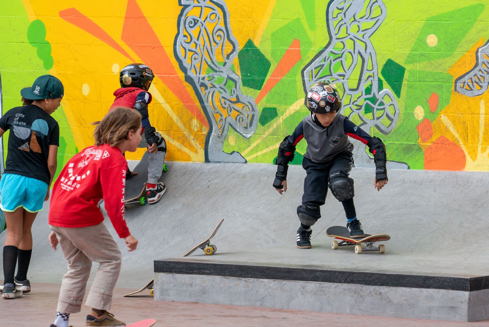 Young people riding skateboards in a skate plaza