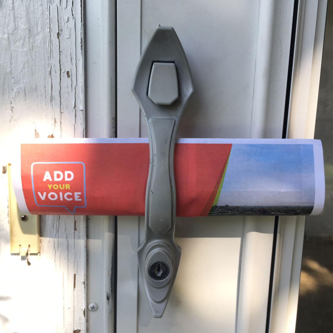 A door handle with a handout with the words add your voice