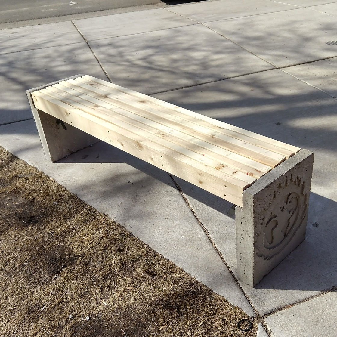 A wooden, concrete, and steel bench designed by Enviro apprentices