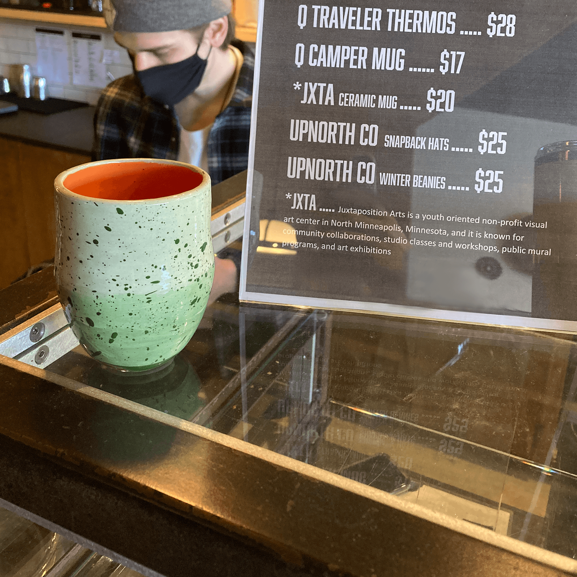 Green ceramic mug near display sign